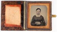 Sixth plate ambrotype of seated young woman with gold necklace housed in faux wood case