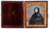 Ambrotype of woman seated with black bonnet and large shawl like wrap