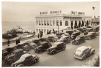 Photograph of San Francisco's Cliff House, with numerous automobiles parked and crowding the street in front