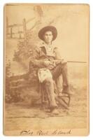 Cabinet photograph buckskin-clad scout holding a rifle in studio setting, captioned Thos. Red Cloud