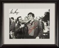 Photograph of Gary Player giving the green coat to Fuzzy Zoeller, signed