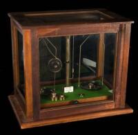 Wood & brass scale in glass housing, with 5 weights