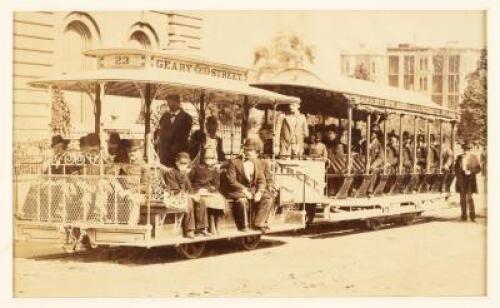 Original albumen photograph of two cable cars in tandem, loaded with passengers, the operator standing by the grip