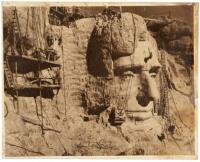 Original photograph of workers carving portraits of Theodore Roosevelt and Abraham Lincoln into Mount Rushmore, with inscription penned and signed by sculptor Gutzon Borglum
