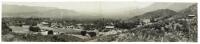 Panorama photograph with wooded hills and scattered buildings