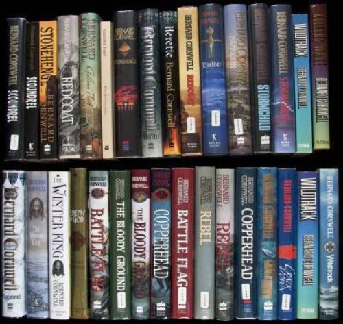 Thirty-two volumes by Bernard Cornwell, comprising 18 different titles in English and American editions, many signed