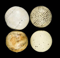 Four vintage golf balls