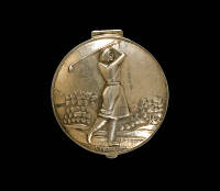 Silver pill box with illustration of lady golfer