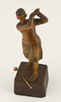 Wooden figurine of a 1920s female golfer