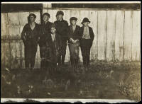 Untitled [six boys standing in front of a fence]