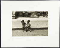 Boys seated on curb, New York City
