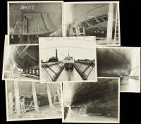 Twenty-four silver photographs of ships being repaired in dry dock