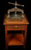 Cast iron French nipping press mounted on antique oak and walnut stand with a single drawer