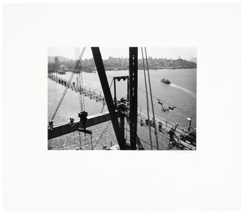 [From a tower top, out on a cross beam]