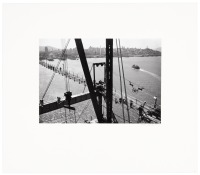 [From a tower top, out on a cross beam]