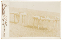 Original photograph of two raised Native American burial platforms with bodies on them