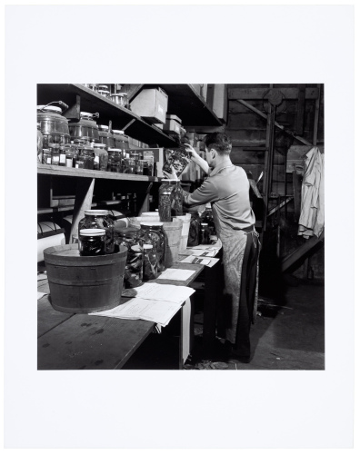 [Ed Ricketts holding jar of specimens at Pacific Biological Laboratories]