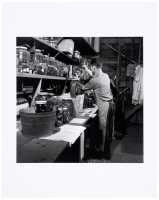 [Ed Ricketts holding jar of specimens at Pacific Biological Laboratories]