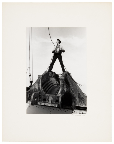 Joe Walton, signalman, astride a cable saddle
