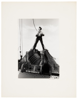 Joe Walton, signalman, astride a cable saddle