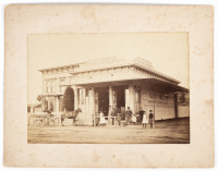 Albumen photograph of a corner grocery & liquor store on an unpaved street in an unidentified town, perhaps in the southwest of the United States