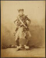 Albumen photograph of male hula dancer in grass skirt