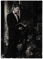 Photograph of man in tux, reading