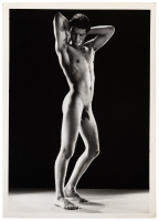 Photograph of brunette standing, nude