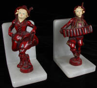 Vintage bookends: Boy playing accordion, girl dancing to the music.