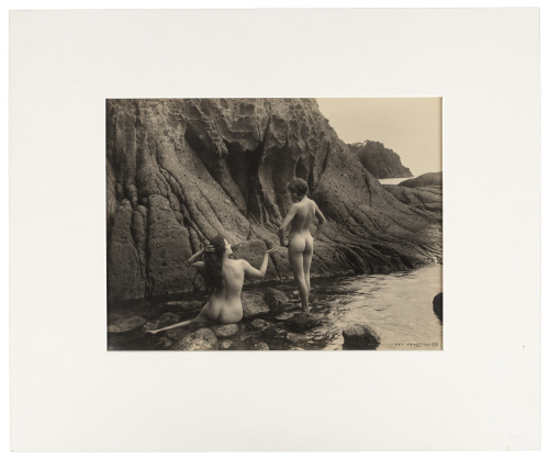 [Two nude figures on rocky coast]