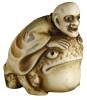 Carved Japanese ivory netsuke of man riding a toad