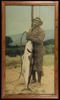 Hand-colored photograph of Zane Grey with World Record yellow tail caught in the waters of New Zealand, from the estate of Zane Grey