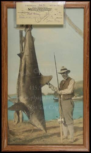 Hand-colored photograph of Zane Grey with a large shark caught in the waters of New Zealand, from the estate of Zane Grey