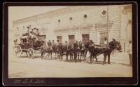 Albumen photograph of a stagecoach pulled by 8 mules parked in front of a Mexican bank