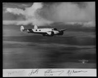 Gelatin silver photograph of Amelia Earhart's Lockeed HE Electra in flight over the water, signed in the negative by Earhart and other members of her crew, dated 3/17/37