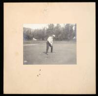 Original black & white photograph of Will Rogers putting on a golf course green