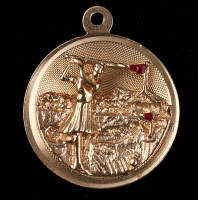 Gold charm of a lady golfer, with 2 mounted ruby chips