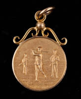 Gold medallion of a trio of golfers