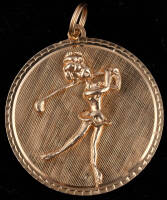 14K gold pendant - circular backing with raised illustration of a lady "bimbo" golfer