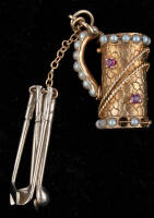 14K gold pendant shaped like a golf bag lined with several pearls