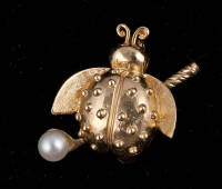 14K gold pin shaped like a ladybug, with golf club and mounted pearl
