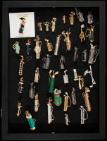 Collection of jewelry, mostly pins, shaped like golf club bags