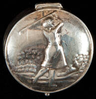 Silver pill box with illustration of lady golfer