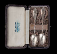 Two silver spoons with golf ball decoration on handle, in original suede box, made in Japan