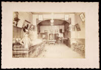 Albumen photograph of the interior of a bar, with billiard table