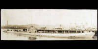 Sepia-tone silver panoramic photograph of a the U.S. Navy submarine V-3 docked at Boston, Massachusetts