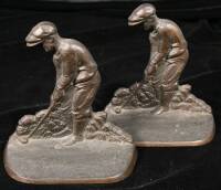 A pair of bronze-plated golfing bookends